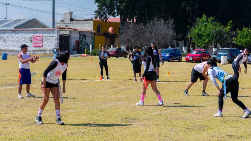 Exciting outdoor flag football game with youth players in Toluca de Lerdo, Mexico.